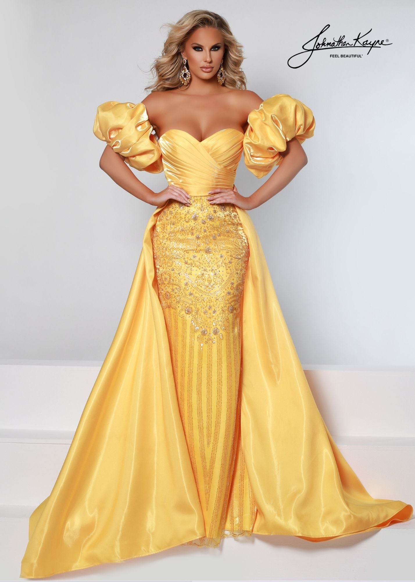 Johnathan Kayne 2502 Shimmer Satin Fitted strapless sweetheart neckline Pageant Dress. Crystal Rhinestone Embellished Bodice with a flowing Overskirt. This Formal Gown Features removable Puff Sleeves for a Fairy Tale Look!  Available Sizes: 00, 0, 2, 4, 6, 8, 10, 12, 14, 16  Available Colors: Marigold, White