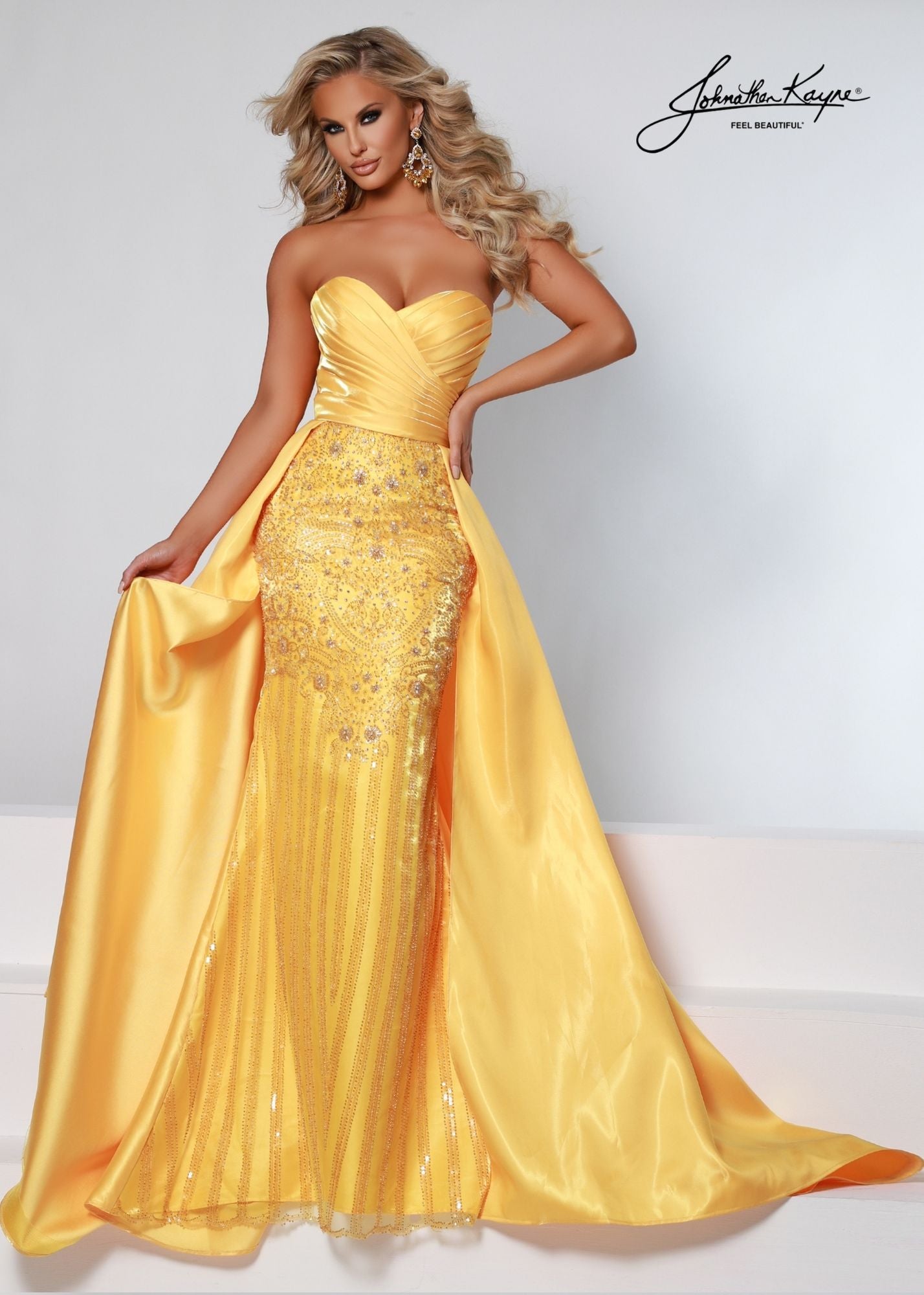Johnathan Kayne 2502 Shimmer Satin Fitted strapless sweetheart neckline Pageant Dress. Crystal Rhinestone Embellished Bodice with a flowing Overskirt. This Formal Gown Features removable Puff Sleeves for a Fairy Tale Look!  Available Sizes: 00, 0, 2, 4, 6, 8, 10, 12, 14, 16  Available Colors: Marigold, White