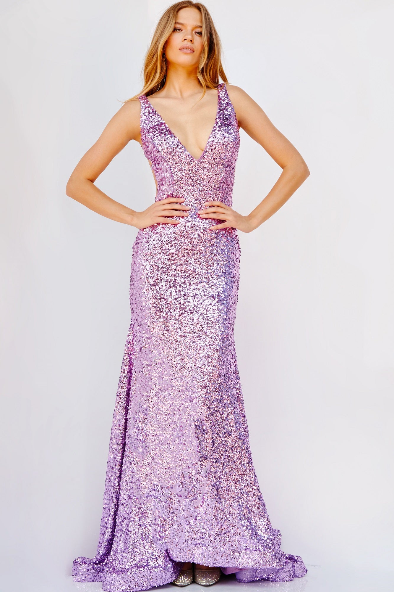Jovani 23079 This long fit and flare prom dress is adorned with shimmering sequins, a plunging V neckline, and finished with an elegant horsehair trim and sweeping train.  Available colors:  Lilac, Emerald, Turquoise, Gold
