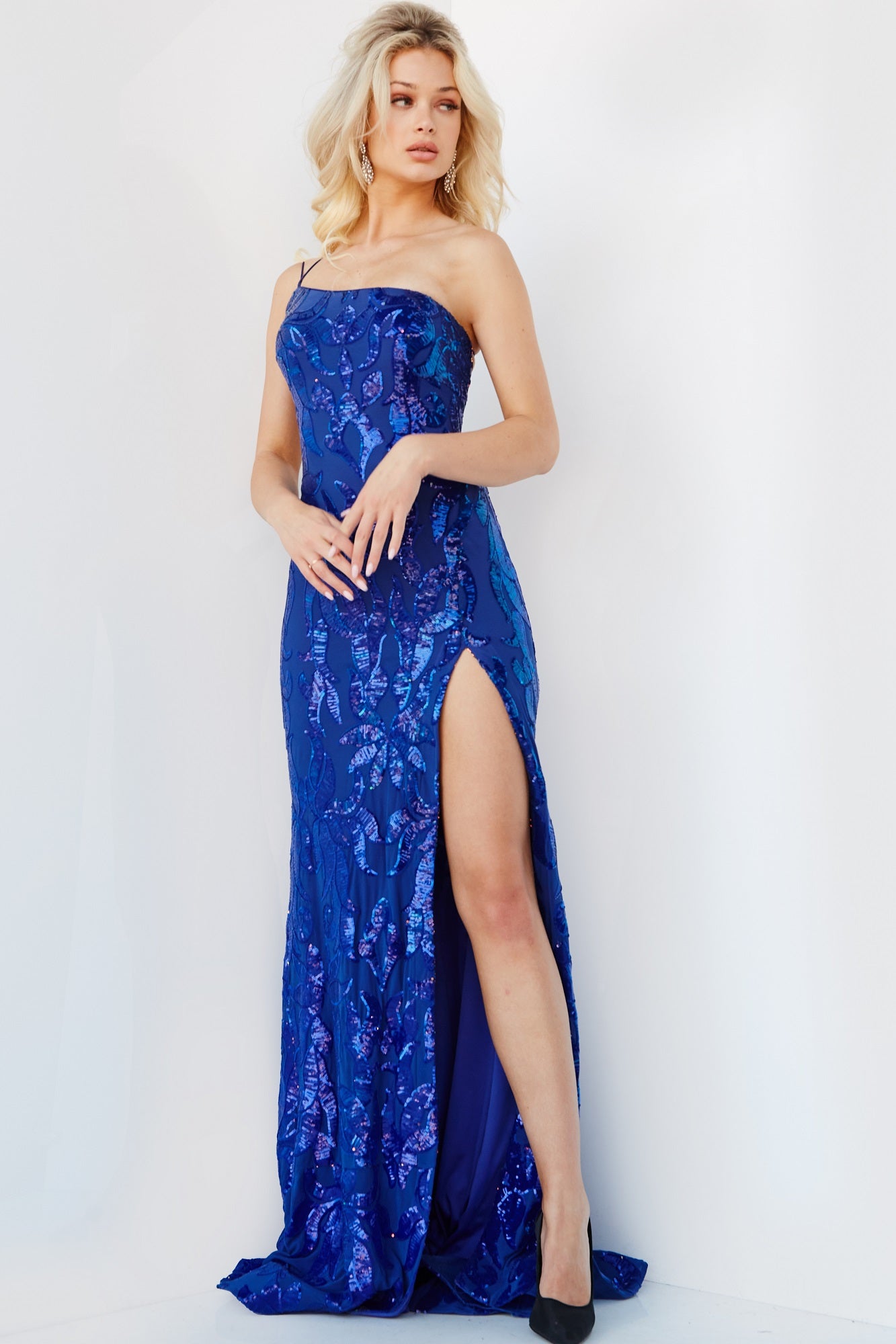 Jovani 07913 prom dress features a strapless fitted bodice made with sparkling sequins. The dress has a high slit that adds a touch of  it has double spaghetti straps that lead to a backless corset