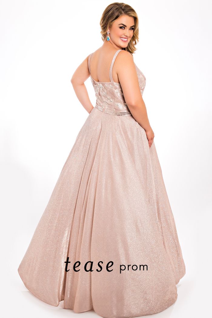 Tease Prom TE2007 straight embroidered neckline a line prom dress evening gown.  Look sexy and sophisticated in our plus size formal dress in rose colored metallic stretch knit fabric. Fabulous embroidered flowers on bodice for a must-have 2021 trend. A-line silhouette with full floor length skirt flatters any body type.  Bring on the bling with a clear and rose gold beaded belt.  Perfect choice for prom or any special occasion.