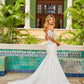 Amarra Bridal Margot 84380 Sheer Lace Off the Shoulder Bridal Gown Mermaid Wedding Dress Margot comes with a deep-v neckline and arm bands that feature a unique floral lace design. The same lace details can be seen throughout the top half of the dress, cascading down to the beautiful flowy skirt. 