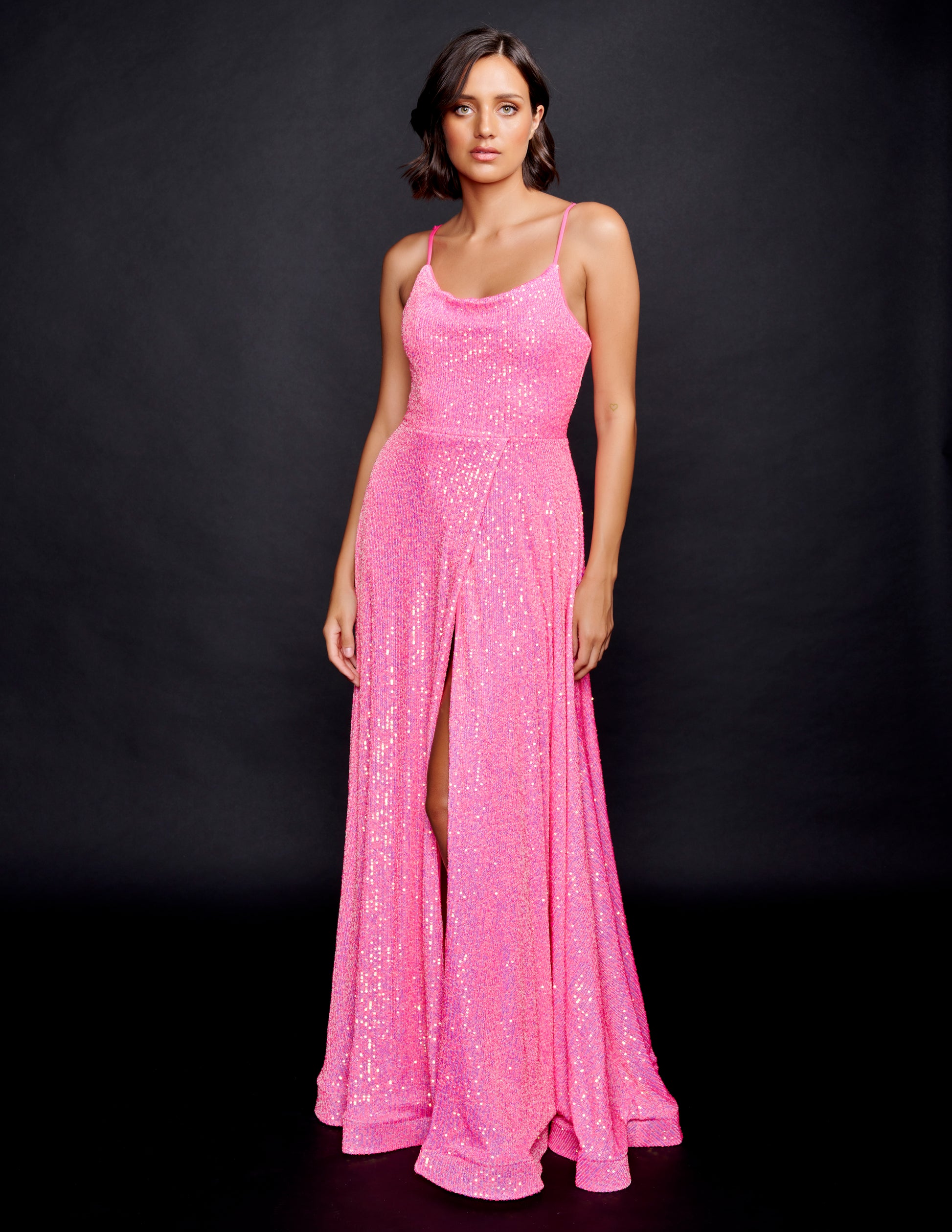 Nina Canacci 1533 Evening Gown, Prom and Pageant Dress.  This is a gorgeous prom dress with iridescent multi sequins that glimmer as you move.  It has a scoop neckline and a lace up corset back.  The floor length skirt on this evening dress has horsehair trim and a wrap style slit bubblegum pink