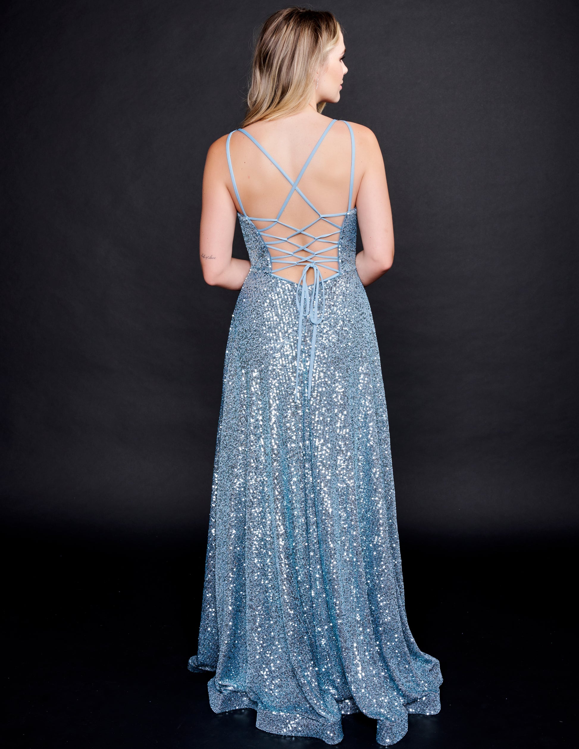 Nina Canacci 1533 Evening Gown, Prom and Pageant Dress.  This is a gorgeous prom dress with iridescent multi sequins that glimmer as you move.  It has a scoop neckline and a lace up corset back.  The floor length skirt on this evening dress has horsehair trim and a wrap style slit.