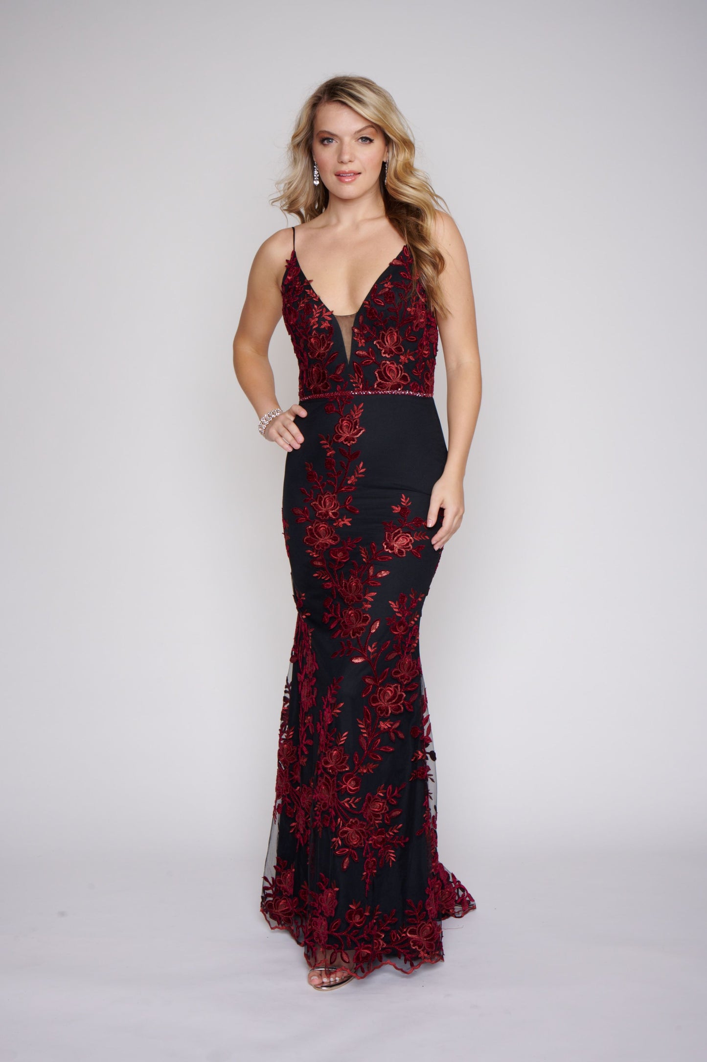 Nina Canacci 2240 Black Burgundy Long Prom Dress Fitted Evening Gown Floral Lace Dress This dress has a v neckline with sheer courtesy panel and a sheer lace back.  It is fully appliqued with Burgundy lace.  The fit and flare design is gorgeous on you and it has a matching embellished belt. 