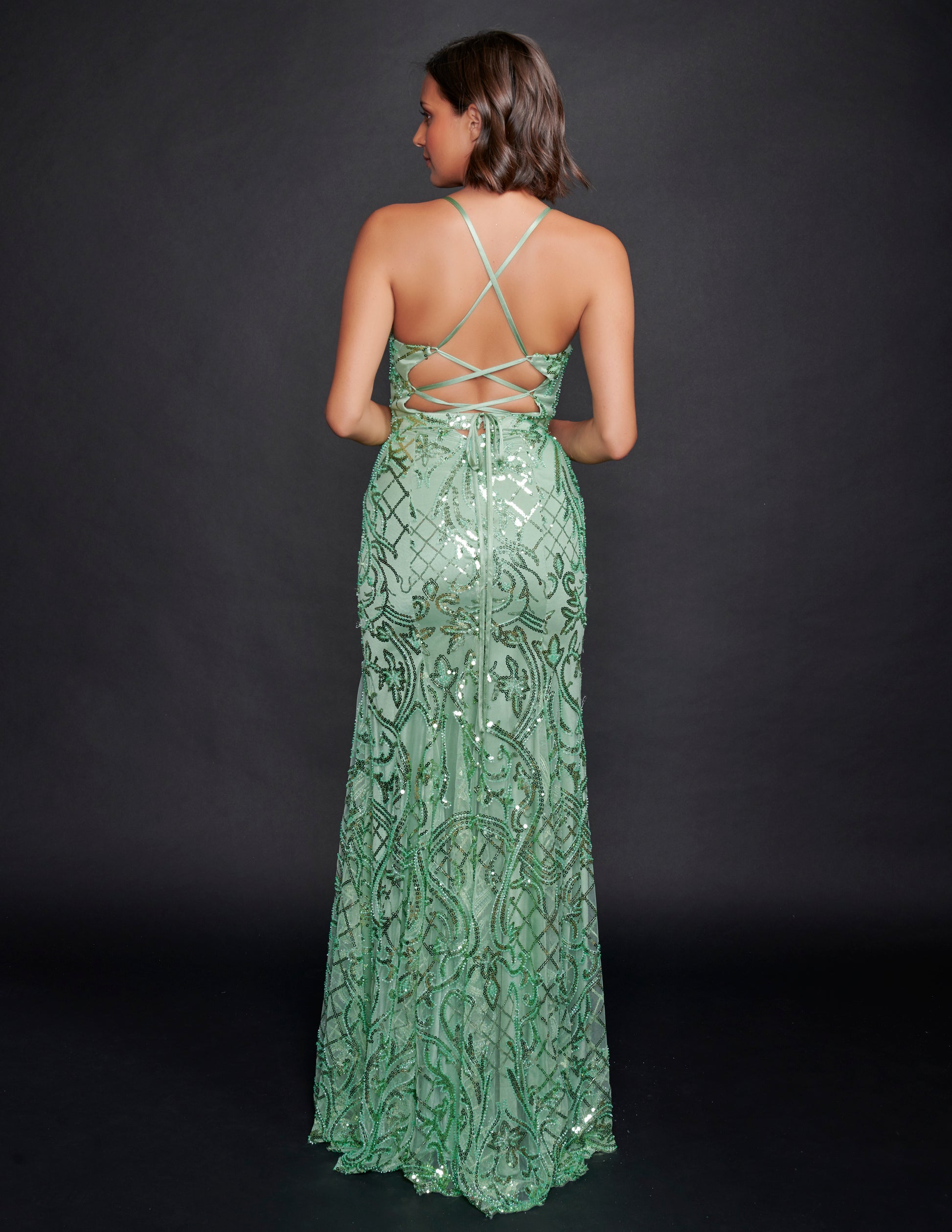 Nina Canacci 6579 Sage Sequin Prom Dress features a scoop neckline with a V in it and sheer panel.