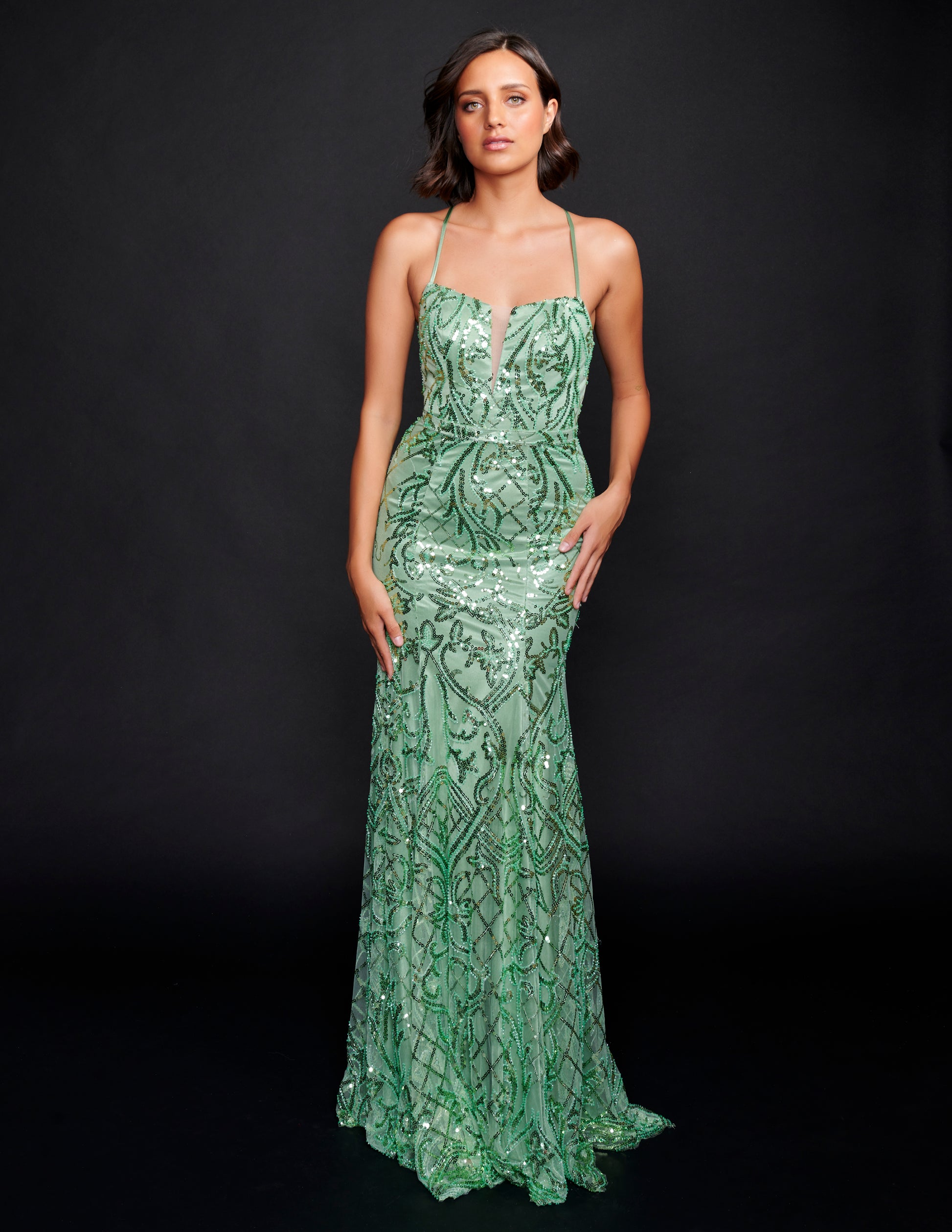 Nina Canacci 6579 Sage Sequin Prom Dress features a scoop neckline with a V in it and sheer panel.