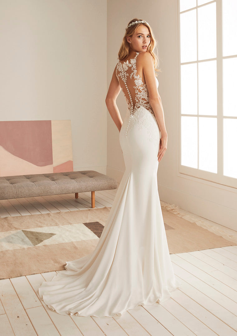 Pronovias White One Bridal OKAPI  Sensuality at its most feminine was the inspiration for this amazing wedding dress with a mermaid silhouette. A design that uses the most suggestive necklines and details to create a sweetly stunning silhouette: