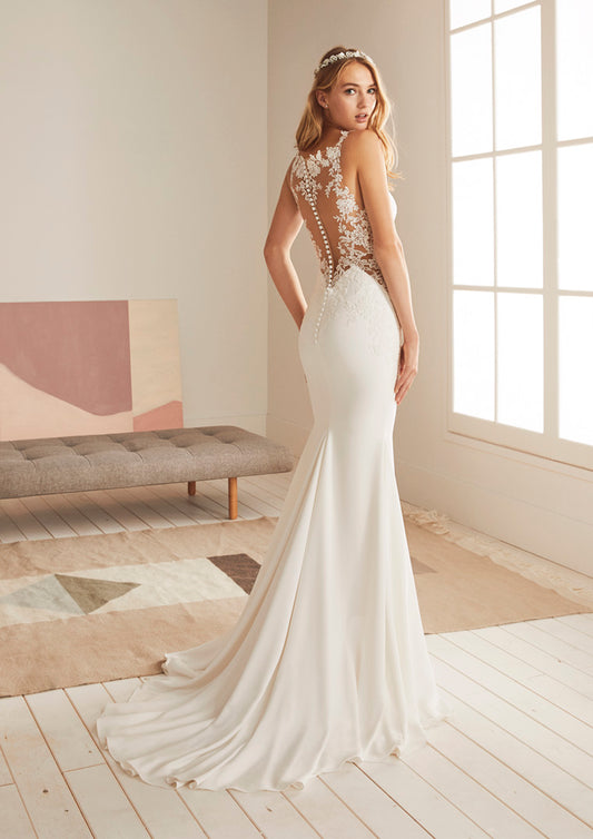Pronovias White One Bridal OKAPI  Sensuality at its most feminine was the inspiration for this amazing wedding dress with a mermaid silhouette. A design that uses the most suggestive necklines and details to create a sweetly stunning silhouette: