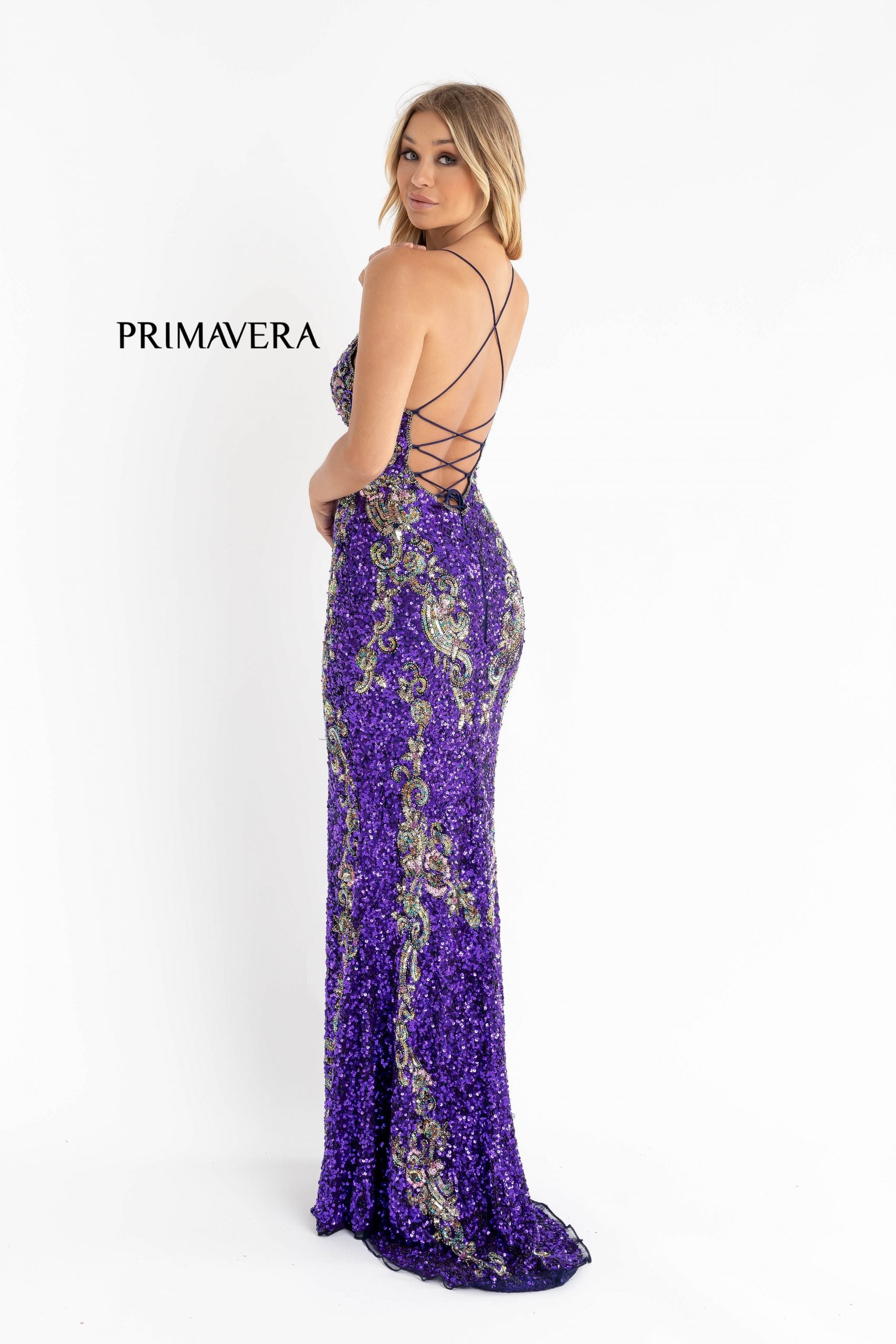 Primavera Couture 3211 Purple is a Long fitted sequin Embellished Formal Evening Gown. This Prom Dress Features a deep V Neck with an open Corset lace up back. Beaded & embellished elegant scroll pattern accentuate curves. Fully beaded prom dress with floral pattern and side slit. Long Sequin Gown featuring a v neckline. slit in the fitted skirt, Slit in Thigh. Stunning Pageant Dress, Prom Gown & More! back