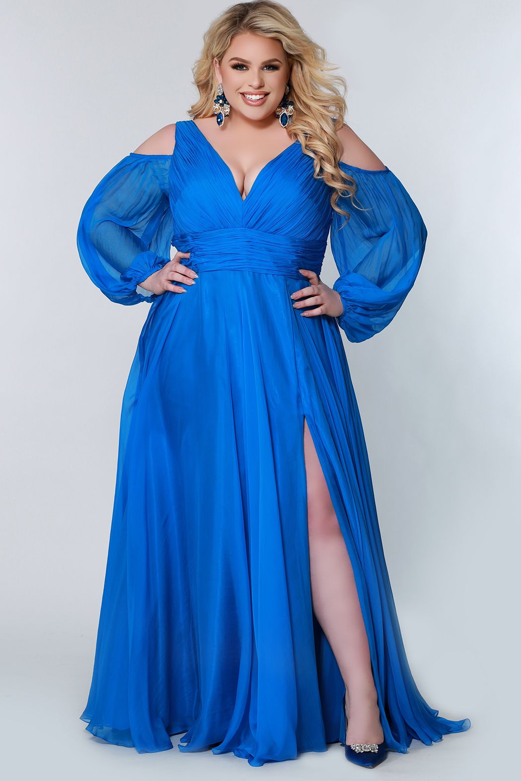 Johnathan Kayne for Sydney's Closet JK2205 A-Line Poly Chiffon Cold Shoulder Long Pouf See-Thru Sleeves Plus Size Prom Dress. Make a fashion statement in the Johnathan Kayne for Sydney's Closet JK2205 prom dress. Crafted from soft poly chiffon, this A-line silhouette features see-thru sleeves and cold shoulders for added drama. With an elegant pouf skirt, this plus size dress ensures superior comfort and absolute confidence.