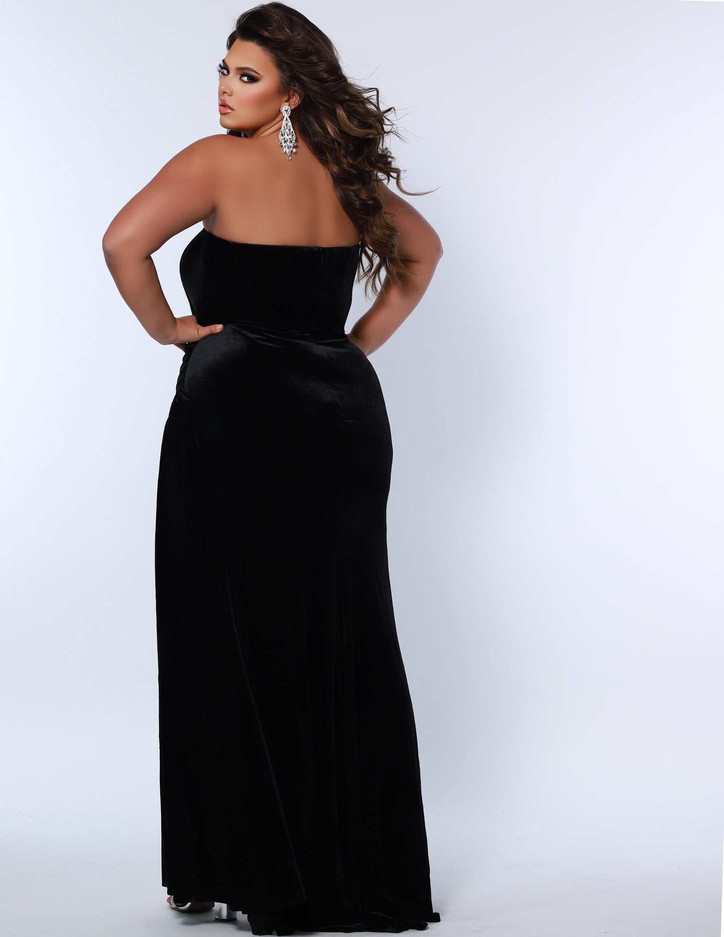 The Sydney's Closet SC7342 is a luxurious Velvet Prom Dress Strapless Evening Gown with a fitted and ruched silhouette, ideal for special occasions. It offers a classic and timeless look with a touch of sophistication. Its rich fabric provides a comfortable fit and feel.