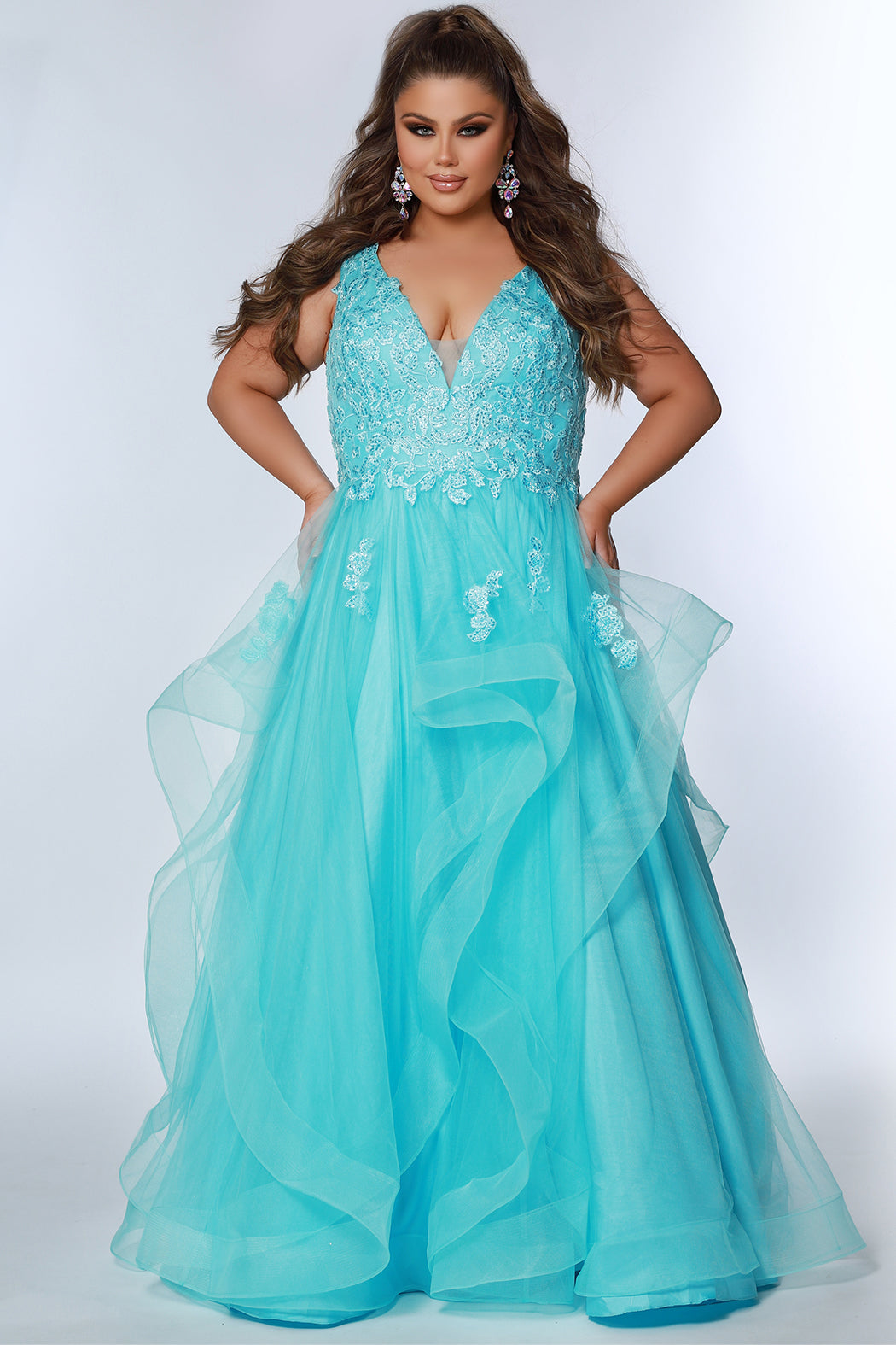 For a lasting impression at prom, the Sydney's Closet SC7347 Floral Lace Bodice dress offers timeless elegance with its layered tulle ballgown skirt and tonal mesh insert. The V-neckline and bra-friendly straps deliver a flattering fit, while the natural waistline and horsehair hem ensure a stylish finish.