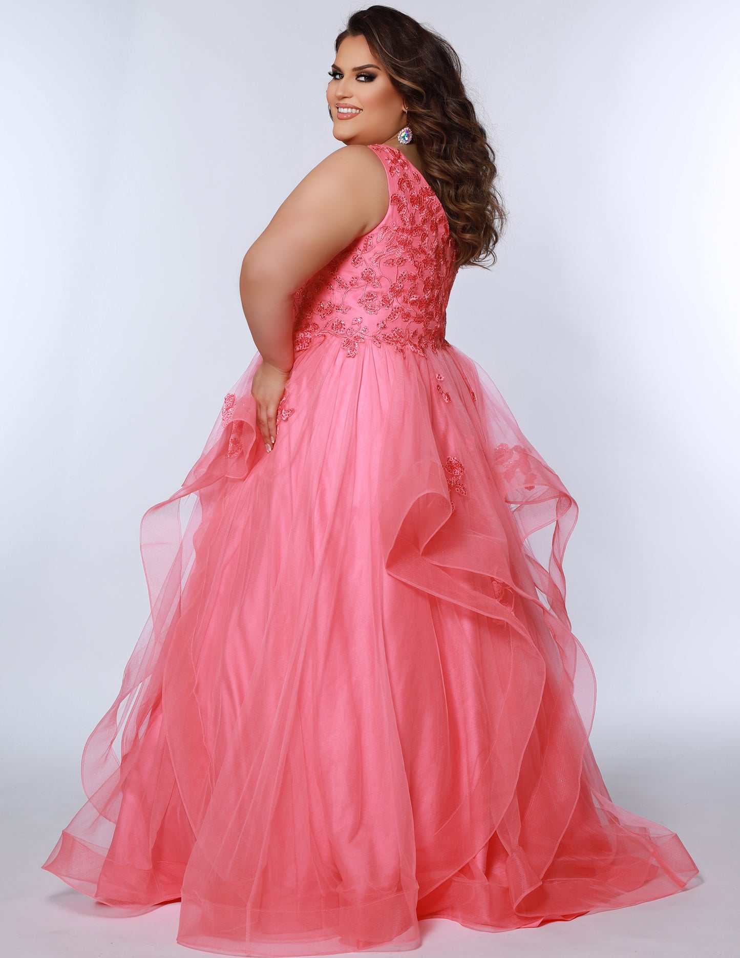 For a lasting impression at prom, the Sydney's Closet SC7347 Floral Lace Bodice dress offers timeless elegance with its layered tulle ballgown skirt and tonal mesh insert. The V-neckline and bra-friendly straps deliver a flattering fit, while the natural waistline and horsehair hem ensure a stylish finish.