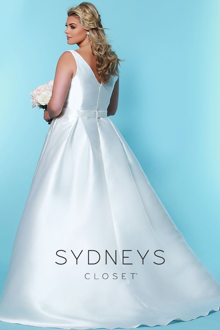 Sydney's Closet SC 5229 Glow from within on your wedding day wearing this simple but strikingly elegant plus size deep v neckline bridal dress. This timeless Mikado satin V-neckline wedding dress comes with a sheer modesty panel. Sweeping A-line skirt flatters every figure. Pockets add a playful - and useful - design detail. Bra-friendly straps and center-back zipper provide style and comfort. Designer Sydney's Closet Style SC5229 for curvy brides who wear plus sizes, super sizes 14 to 40.