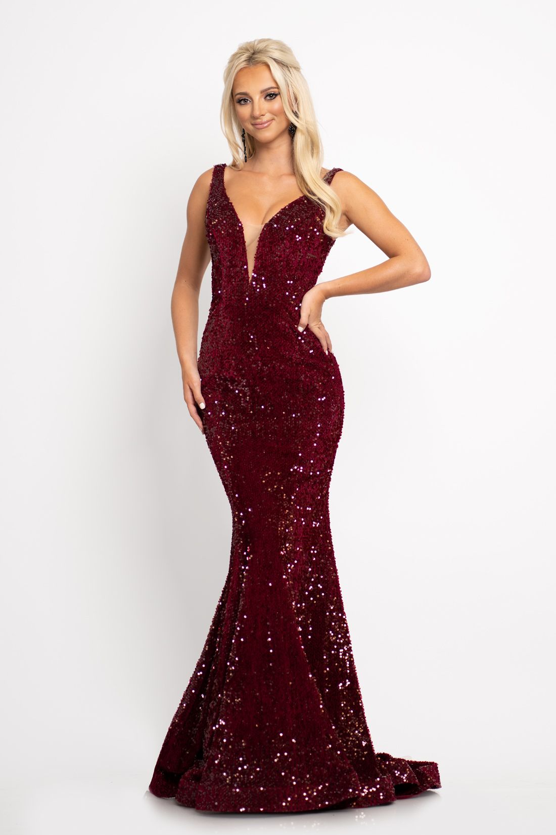 Johnathan Kayne 2237 This long prom dress has a plunging v neckline with mesh panel and a mid v back and is made of luxurious stretch velvet scattered with sequins.  The long mermaid skirt on this pageant gown has a sweeping train. Colors  Crimson, Emerald  Sizes  00, 0, 2, 4, 6, 8, 10, 12, 14, 16, 18, 20, 22