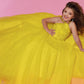Sugar Kayne C143 Girls and Preteens Pageant Dress.  This is a beautiful flowy organza pageant gown with embellished high neckline.  This dress features an organza ruffle that flows down the back of the dress yellow