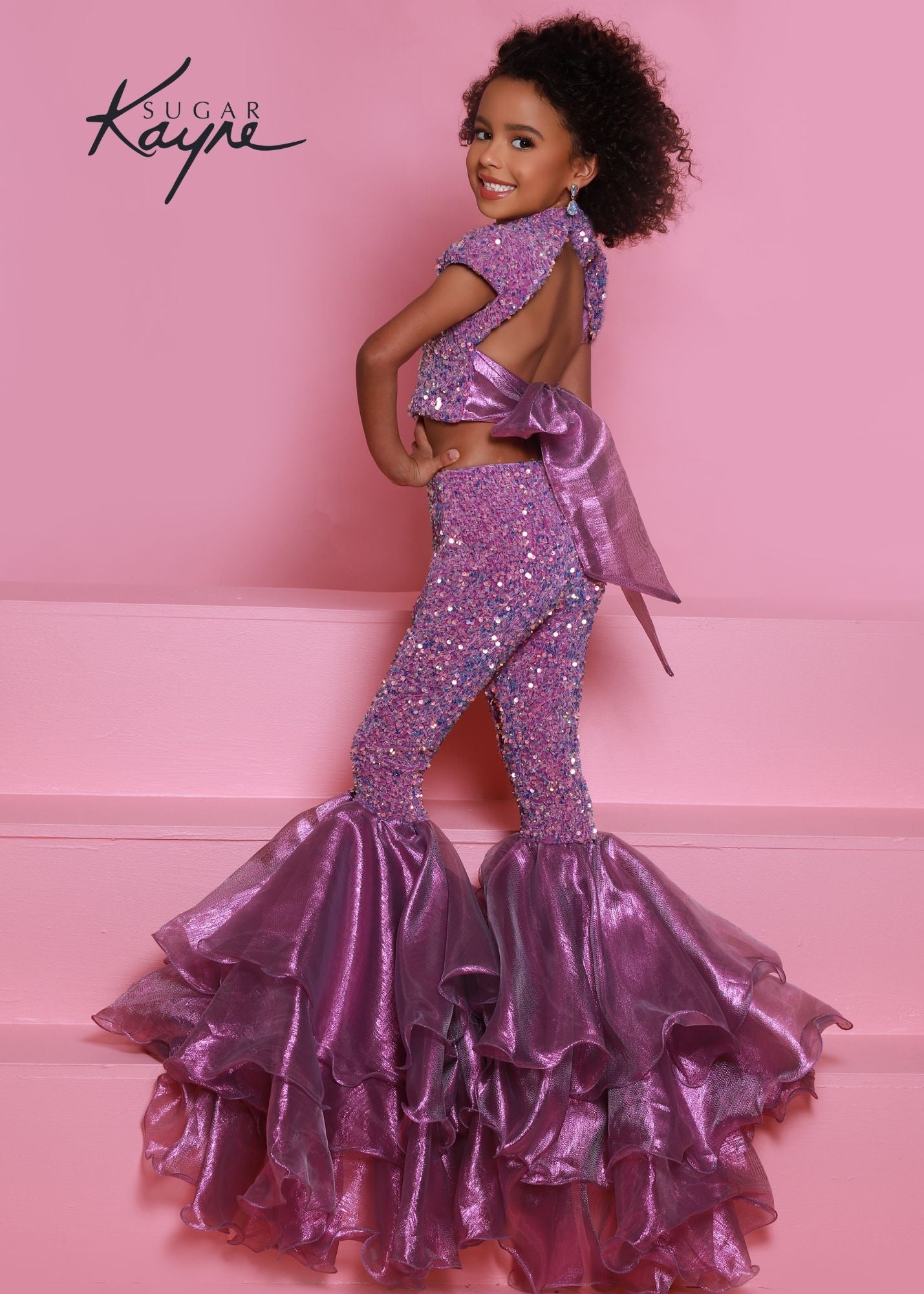 Sugar Kayne C164 This is a two piece girls fun fashion jumpsuit. Featuring Sequin stretch velvet fabric not only is it comfortable but glamorous on stage! high neckline with short sleeves, Backless with an organza bow to tie. Lush Bell Bottoms. Unicorn color features iridescent shimmer organza while royal and red feature regular organza. orchid purple