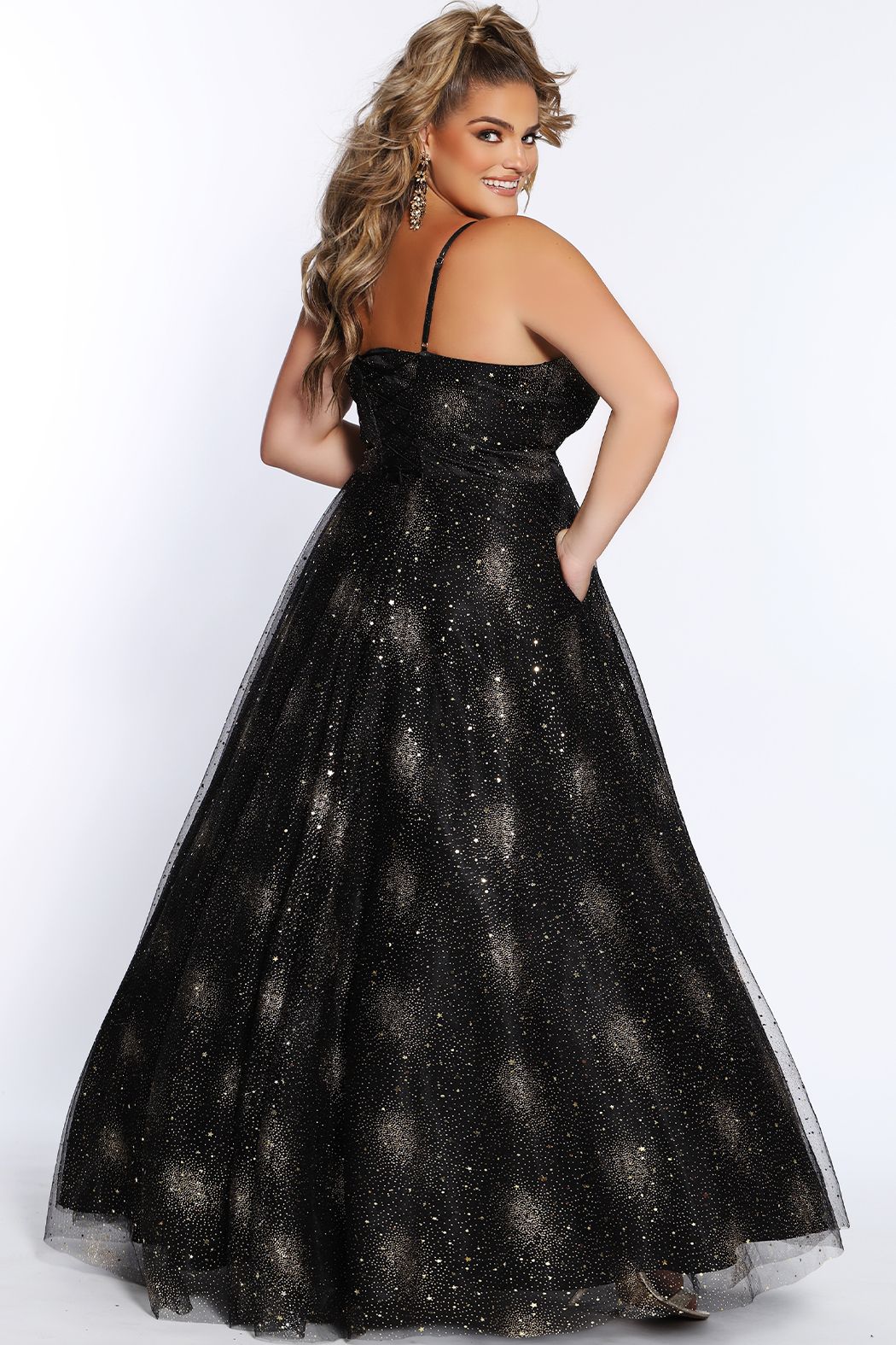 Sydney's Closet SC7327 Stunning in Black or Ivory, this prom dress has delicate details of adjustable spaghetti straps into the lace-up back with modesty panel offers the perfect amount of support. The bodice and full a line skirt shines under the lights with gold stars, moons, and glitter. Made even better with phone-friendly pockets. SC 7327