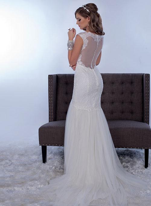 Adagio Bridal by Karishma Creations W 9268 is a stunning lace fitted bodice with a scallop lace V neckline with a sheer lace embellished back. Fitted Mermaid Silhouette with a soft trumpet tulle skirt. Petite sequins allow the lace to glisten. Sheer lace cap sleeve. Sweeping train.  Size 8  Color Ivory