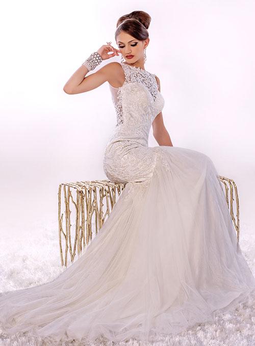 Adagio Bridal By Karishma Creations W 9269 is a stunning sheer lace high neck Wedding dress. Lush lace fitted bodice with fit & Flare mermaid silhouette. sheer lace floral applique full back with button in center. Lush soft tulle subtle trumpet skirt with sweeping train.   Sizes 10, 12  Color Ivory
