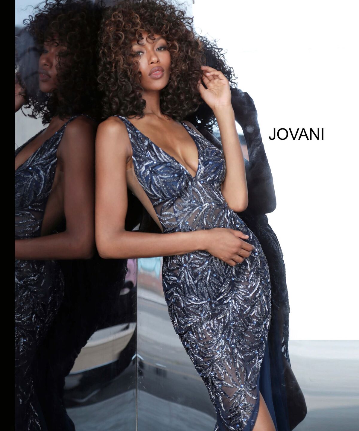 Jovani 1863 is a Gorgeous sheer Fully embellished Plunging Deep v neckline prom dress & Formal evening gown with slit in the sheer column skirt. Fully Embellished Crystal accented beaded sheer fitted bodice. Sheer side panels with mesh inserts.   Available colors:  Navy, Red, Silver/Nude, White  Available sizes:  00-24 