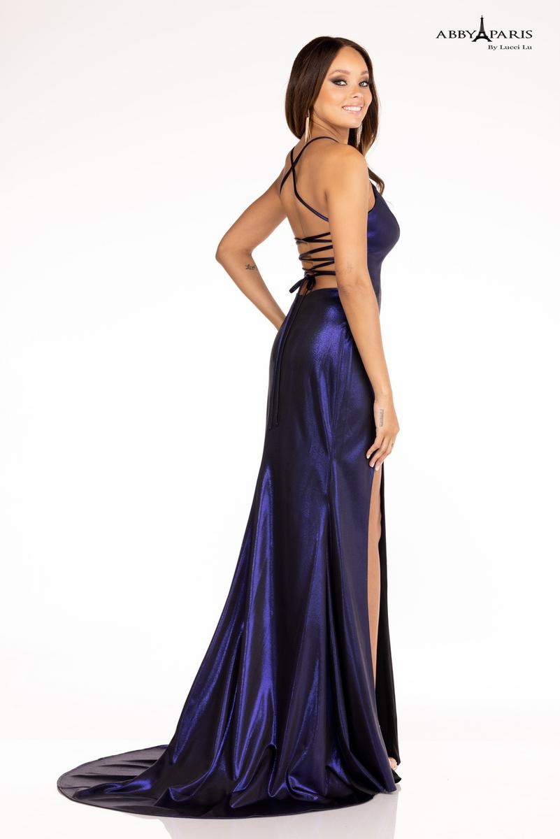 The Abby Paris 90124 is a long, fitted gown made of metallic shimmer fabric with a deep corset back and a high-low slit. Its slim silhouette is designed to flatter, while the corset lacing accentuates the figure and the slit adds a touch of allure. Perfect for formal occasions.  Sizes: 2  Colors: Midnight Blue