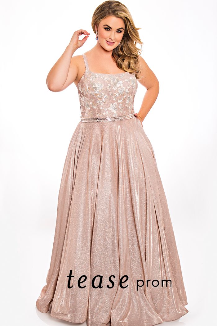 Tease Prom TE2007 straight embroidered neckline a line prom dress evening gown.  Look sexy and sophisticated in our plus size formal dress in rose colored metallic stretch knit fabric. Fabulous embroidered flowers on bodice for a must-have 2021 trend. A-line silhouette with full floor length skirt flatters any body type.  Bring on the bling with a clear and rose gold beaded belt.  Perfect choice for prom or any special occasion.