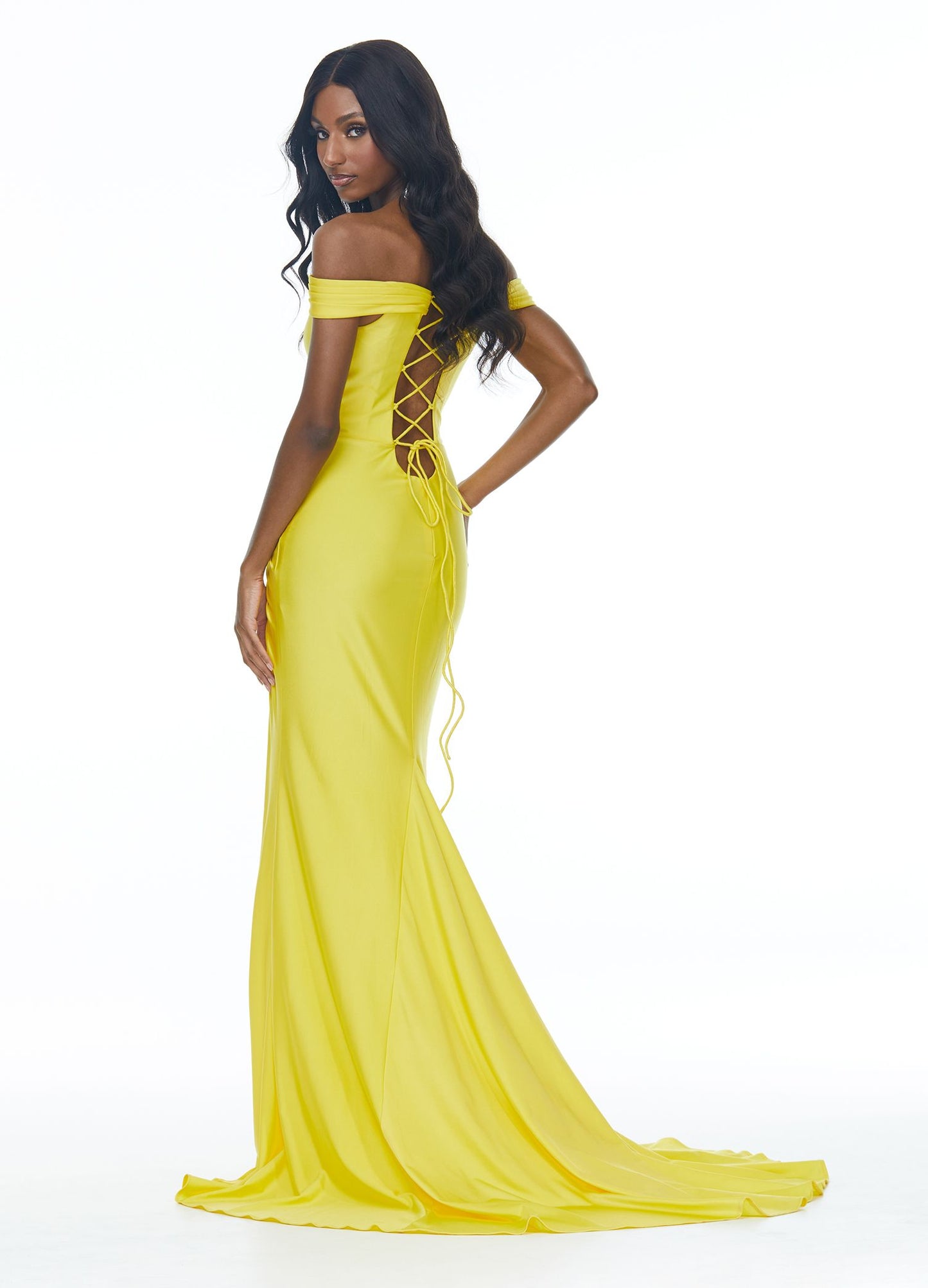 Ashley Lauren 11031 This jersey prom dress has a ruching along the off shoulder straps and waistline, crystal detailing, a modern cut out and lace up back. The skirt on this long pageant evening gown is complete with a left leg slit.  Colors  Yellow, Royal  Sizes  0, 2, 4, 6, 8, 10, 12, 14, 16  Off Shoulder Cut Out Slit Lace up Back