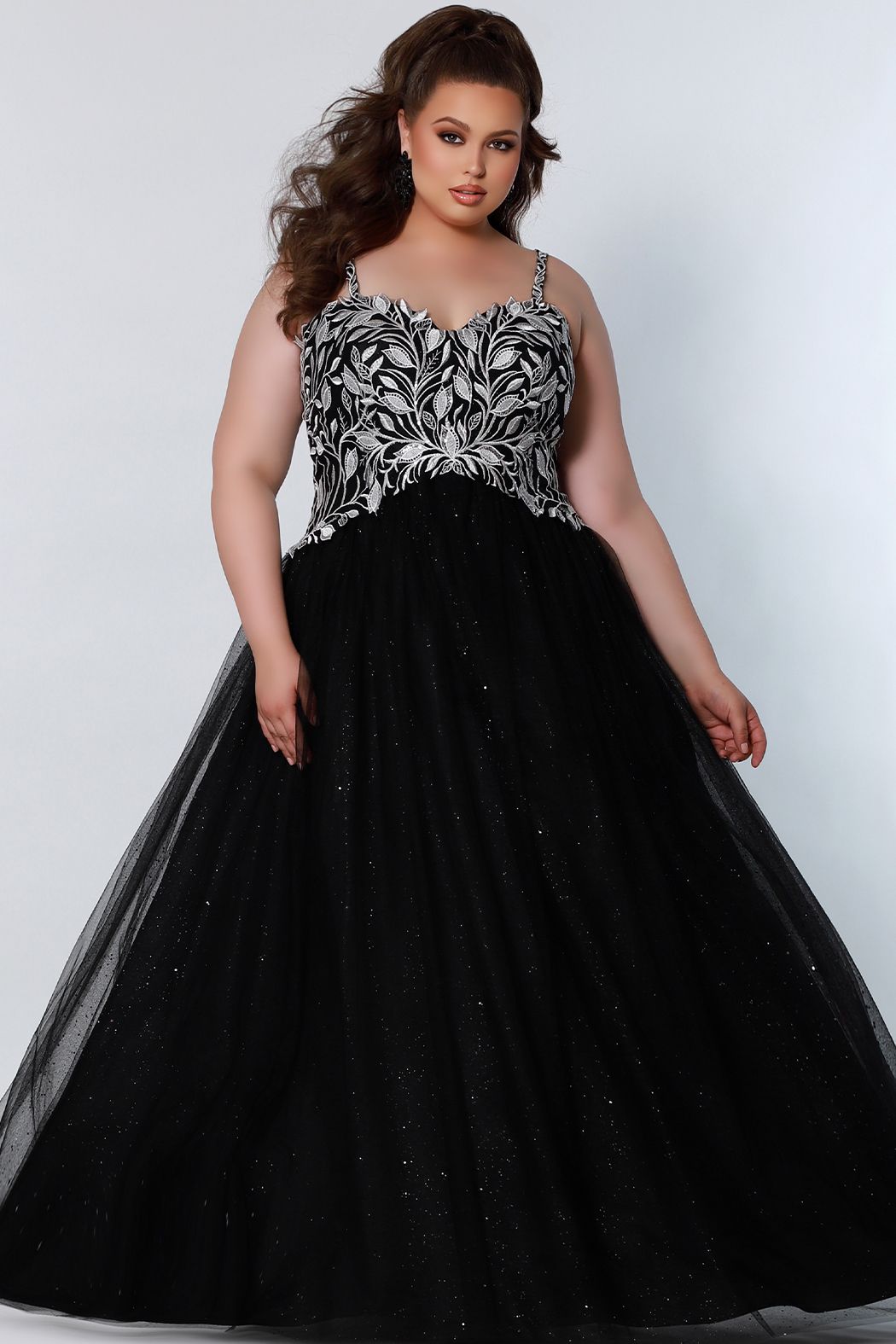 Sydney's Closet SC7329 This prom dress is full of romantic design details from the sweetheart neckline, white embroidered lace appliques, and lace-up back with modesty panel. A voluminous ball gown skirt completes the fairytale with layered tulle and glitter tulle.  Available colors:  Black, Platinum, Royal, Red  Available sizes:  14-40