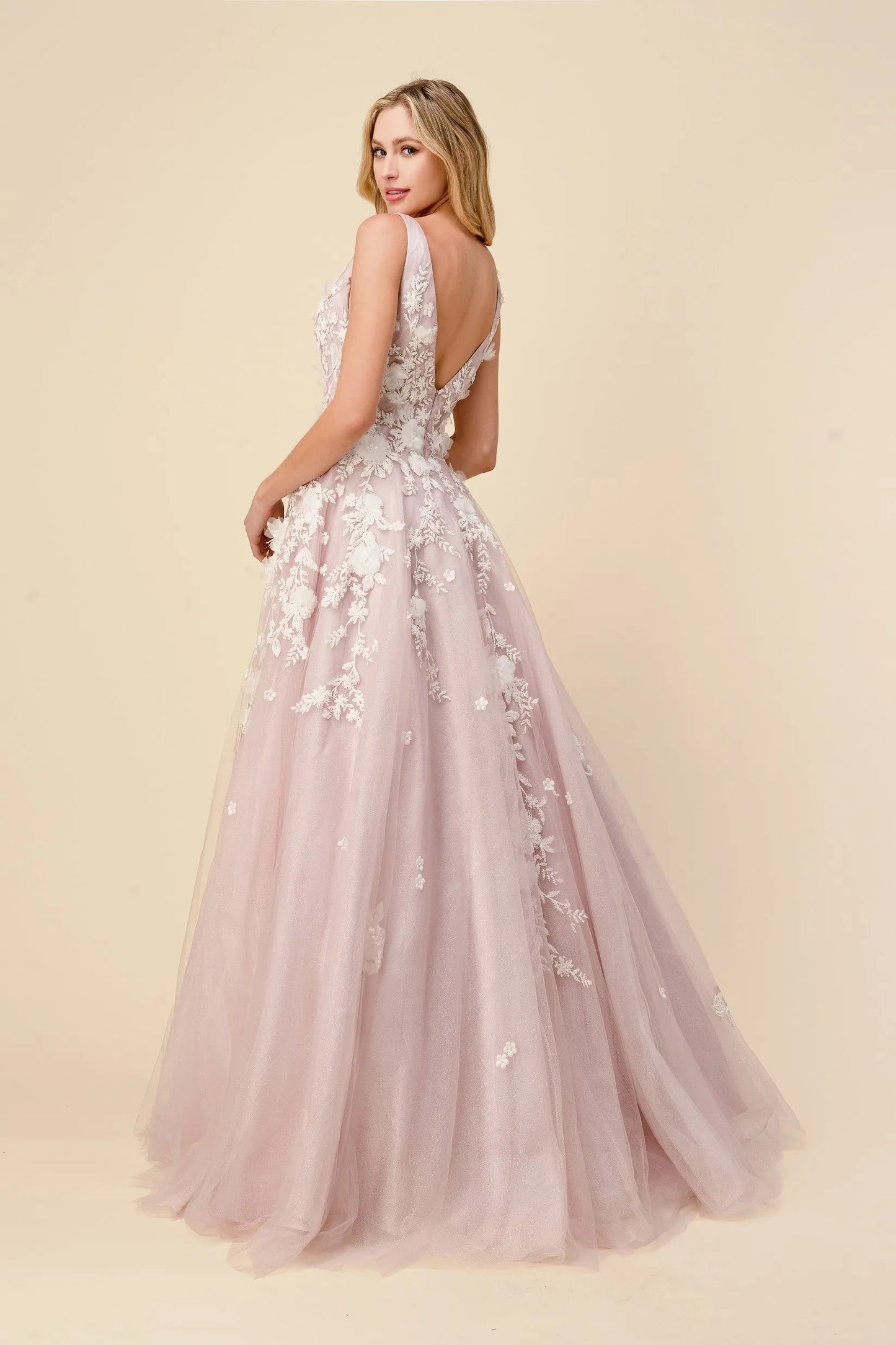 Andrea & Leo Gardenia A1028 Long Shimmer Ball Gown 3D Lace Formal Dress V Neck Gardenia gown is a layered tulle ball gown with floral diamond glitter motif trickling down the gown. 3D organza flowers add couture depth to the garment, while the pastel tone of the dress provides soft backdrop to the floral shimmer. The bodice features a illusion V-neckline with sheer side with deep V-back. The skirt is A-line shape with crinoline to support the silhouette.