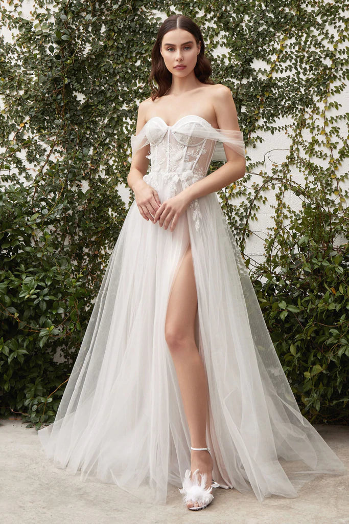 Andrea & Leo Couture VALERIA A1036 Sheer Maxi Slit off Shoulder Wedding Dress Bridal Gown The Valeria is a sweetheart gown with a spark of drama. The modern sweetheart corset is framed with sheer off-shoulder tulle that turns to reveal a tie-back cape. Organza floral embellishment adorns the waistline and glitter applique whimsically overlays the glittering corset bodice & the soft, tulle skirt. 