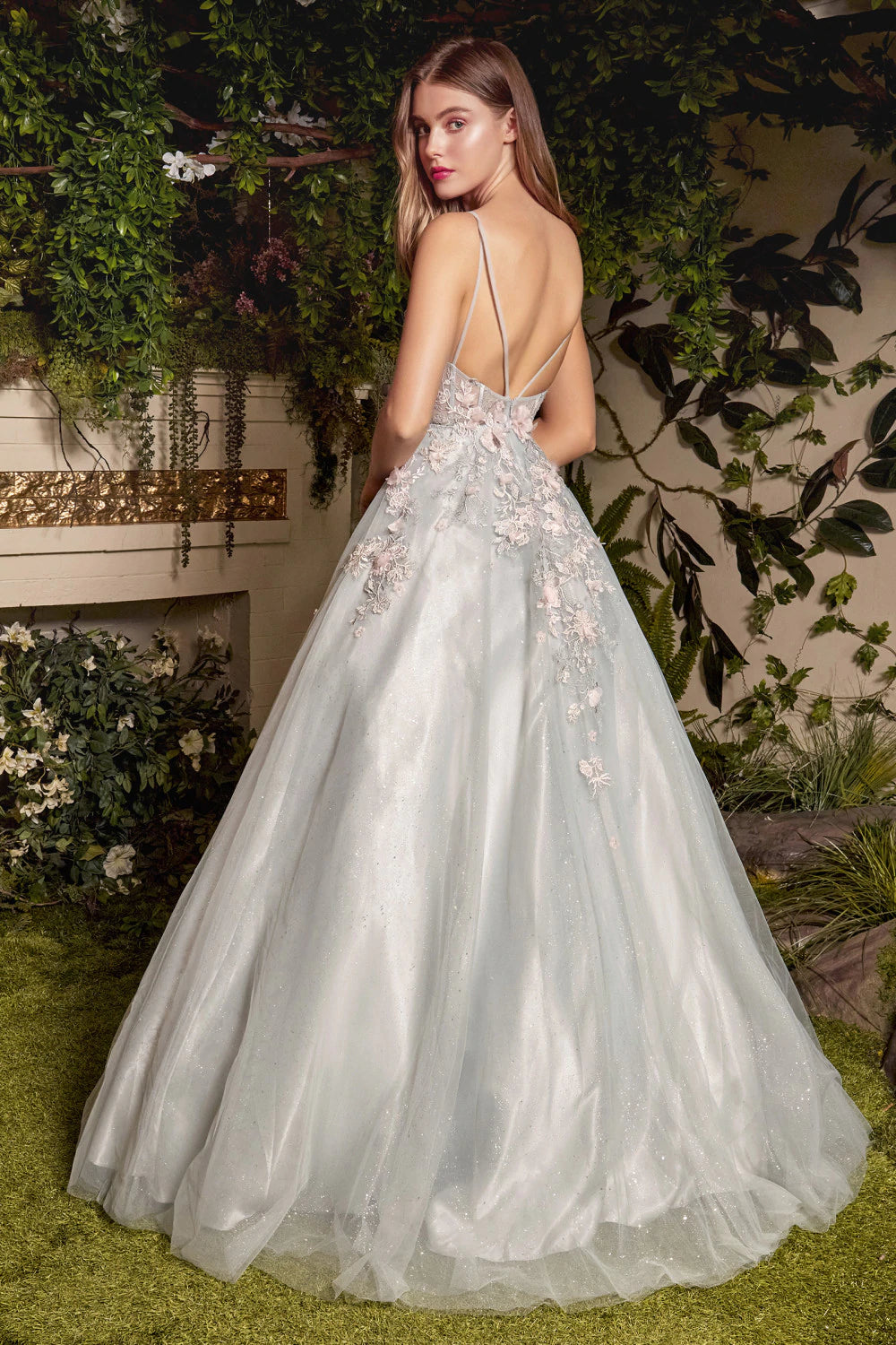 Andrea & Leo TIANA A1040 Long Shimmer A Line Ballgown 3D Lace Formal Dress Sheer Gown Andrea & Leo A1040 this gown features blush 3D organza florals appliqués over sage embroidery on a sheer corset bodice. The A-line silhouette accentuates the wearer's waist, and the ballgown skirt truly brings forth the fairytale aesthetic. Soft, romantic, and ethereal, this ballgown is reminiscent of forgotten gardens.  Available Sizes: 4-14  Available Colors: Sage