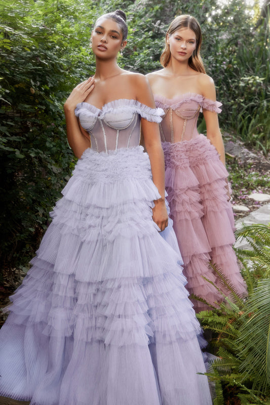 The Andrea & Leo Couture 1150 Long off The Shoulder Pleated Ruffle Ballgown Sheer Prom Dress is perfect for making a magical entrance. It features a boned, sheer bodice adorned with delicate rhinestones, ruffles and an eye-catching corset lace-up back. The elegant pleated ruffle skirt and off the shoulder sleeves provide added drama, while the corset style helps ensure a perfect fit.  Sizes: 2-14  Colors: Blue, Mauve, Yellow