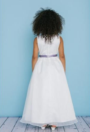 Rosebud Fashions Style 5109 is a full length sleeveless dress with a scoop neckline. The natural waist is accented with a satin ribbon and broach. Satin buttons cover the zipper. Flower Girl dress, First Communion  Available Sizes: 2,4,6,8,10,12,14,16  Available Colors: Ivory, White