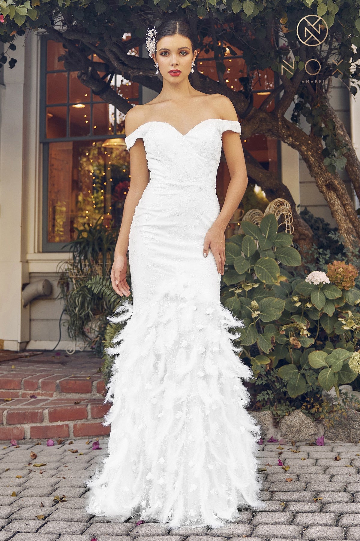 Nox Anabel C1106W Long Fitted Mermaid with Feather embellished skirt. Fitted Lace Bodice with shimmer Wedding Gown Prom Dress off the shoulder straps. Colors: White  Sizes: 2-16