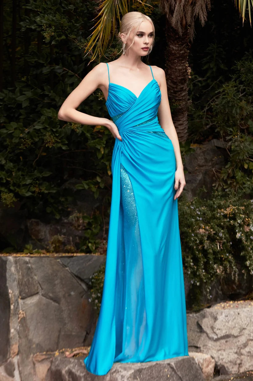 The elegance of the Ladivine CDS410 Long Fitted Teal Jersey Sheer Crystal Slit Overskirt prom dress Pageant Gown sets it apart, featuring a v-neckline gathered bodice with hot stone cut outs and leg slit, as well as a low open scoop back that sparkles in the light. Its ruched booty detail creates a standout silhouette.  Sizes: 6-18  Colors: Teal 