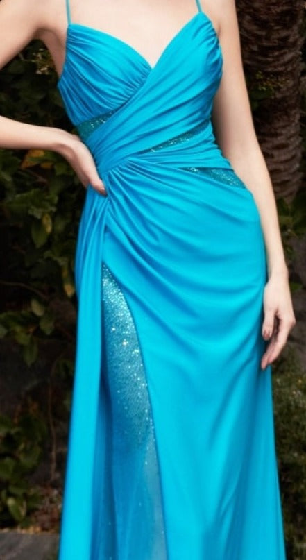 The elegance of the Ladivine CDS410 Long Fitted Teal Jersey Sheer Crystal Slit Overskirt prom dress Pageant Gown sets it apart, featuring a v-neckline gathered bodice with hot stone cut outs and leg slit, as well as a low open scoop back that sparkles in the light. Its ruched booty detail creates a standout silhouette.  Sizes: 6  Colors: Teal 