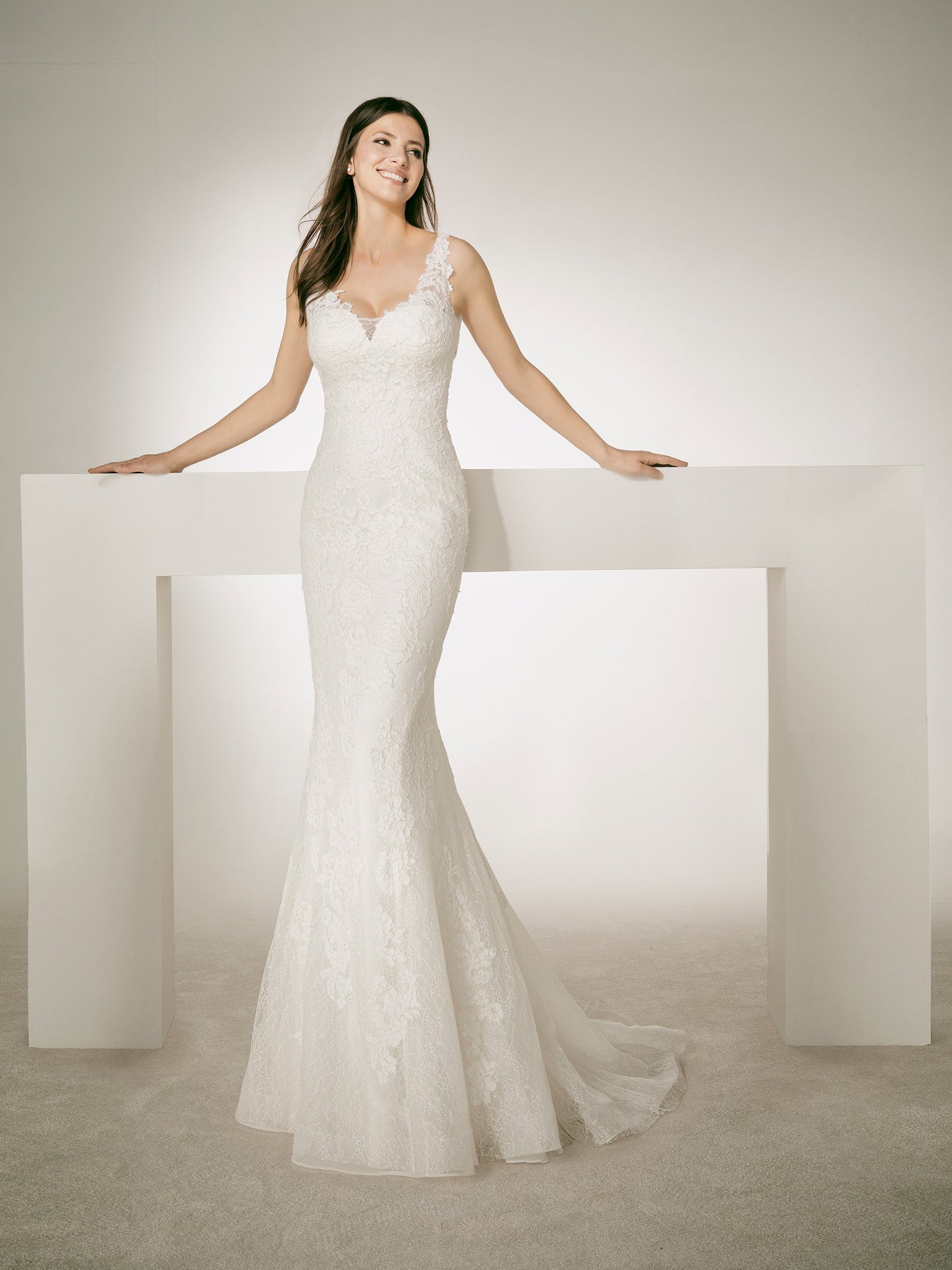 White One Bridal CHRIS is a long Lace Fitted Mermaid wedding Dress. Featuring a Plunging V neckline and sheer lace straps.  IN STOCK FOR IMMEDIATE DELIVERY  US SIZE 10 - OFF WHITE