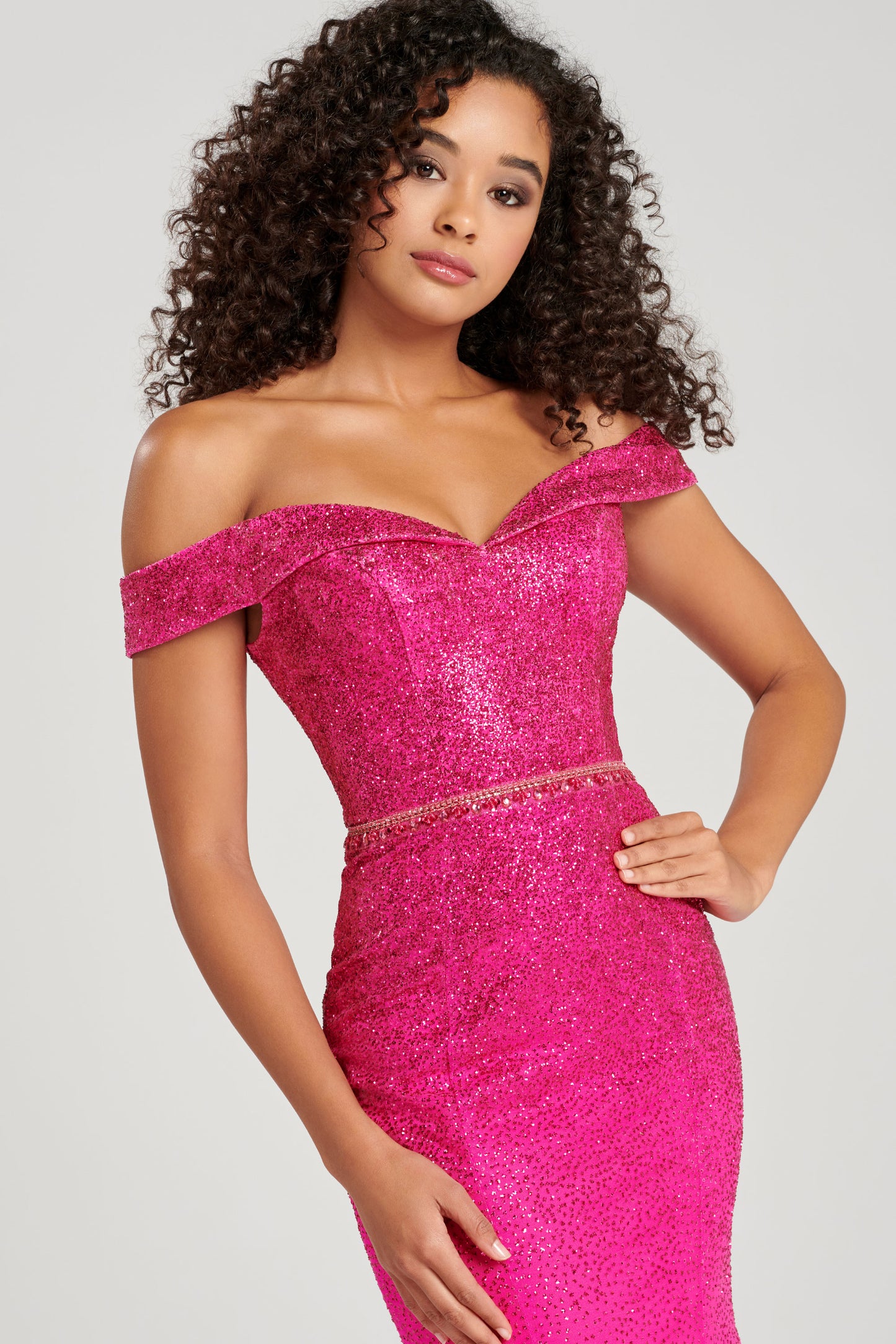 Ellie Wilde EW120028 - EW 120028 Sleeveless sequin lace fit and flare gown with a plunging V-neck, natural waist, criss cross back, horsehair hem and a sweep train. Glittering V-neckline evening gown by Ellie Wilde