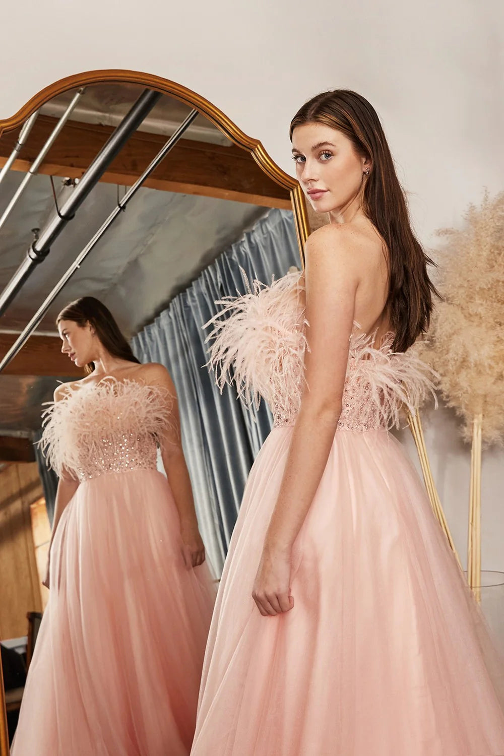 This gorgeous ladivine dress features luxurious long blush tulle fabric and sequin embroidery for an eye-catching look. Its A-line design and strapless silhouette offer a flattering fit for any special occasion. Lightweight and comfortable, the feather trim adds an elegant finish to this show-stopping gown.  Size: 4  Color: Blush