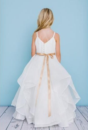 Rosebud Fashions Style 5132 is a full length dress with spaghetti straps and a pleated organza bodice. It features an organza asymmetrical skirt with horse hair trim. The waist is accented by a bling ribbon that ties to a bow in the back. Satin buttons cover the zipper. Flower Girl Dress V Neck Firs Communion Layered Ruffle skirt.