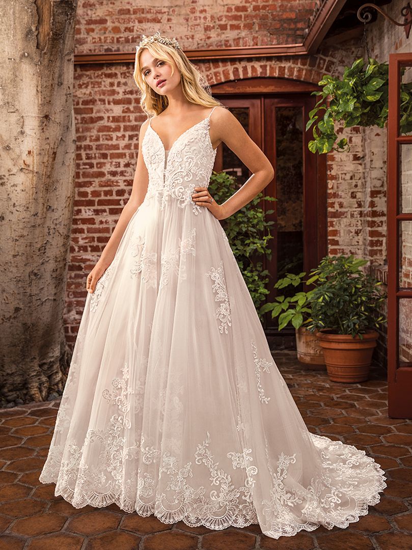 Casablanca Beloved STYLE BL286 DELILAH Other-worldly grace surrounds Delilah, swimming in sateen satin and tulle. Lace appliques cover the bodice and cascade down the flowing skirt of this bohemian wedding gown from Beloved by Casablanca Bridal. Spaghetti straps and a plunging neckline add a seductive touch, transitioning into an alluring illusion lace back. Subtle silver beading catches the light, while a matching veil finishes off this modern boho gown with a glimmer!