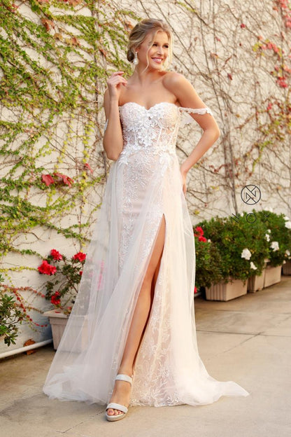 Nox Anabel E 441 OFF SHOULDER BOHO INSPIRED TULLE LAYERS A-LINE GOWN A romantic update to the traditional bohemian style, falls in love with this boho wedding dress with the empire waist by NOX ANABEL. This long dress features an off the shoulder sweetheart neckline on a fitted bodice adorned with tussle lace embellishments. It displays a thigh-high slit and uses tulle fabric that is perfect for a memorable wedding day.