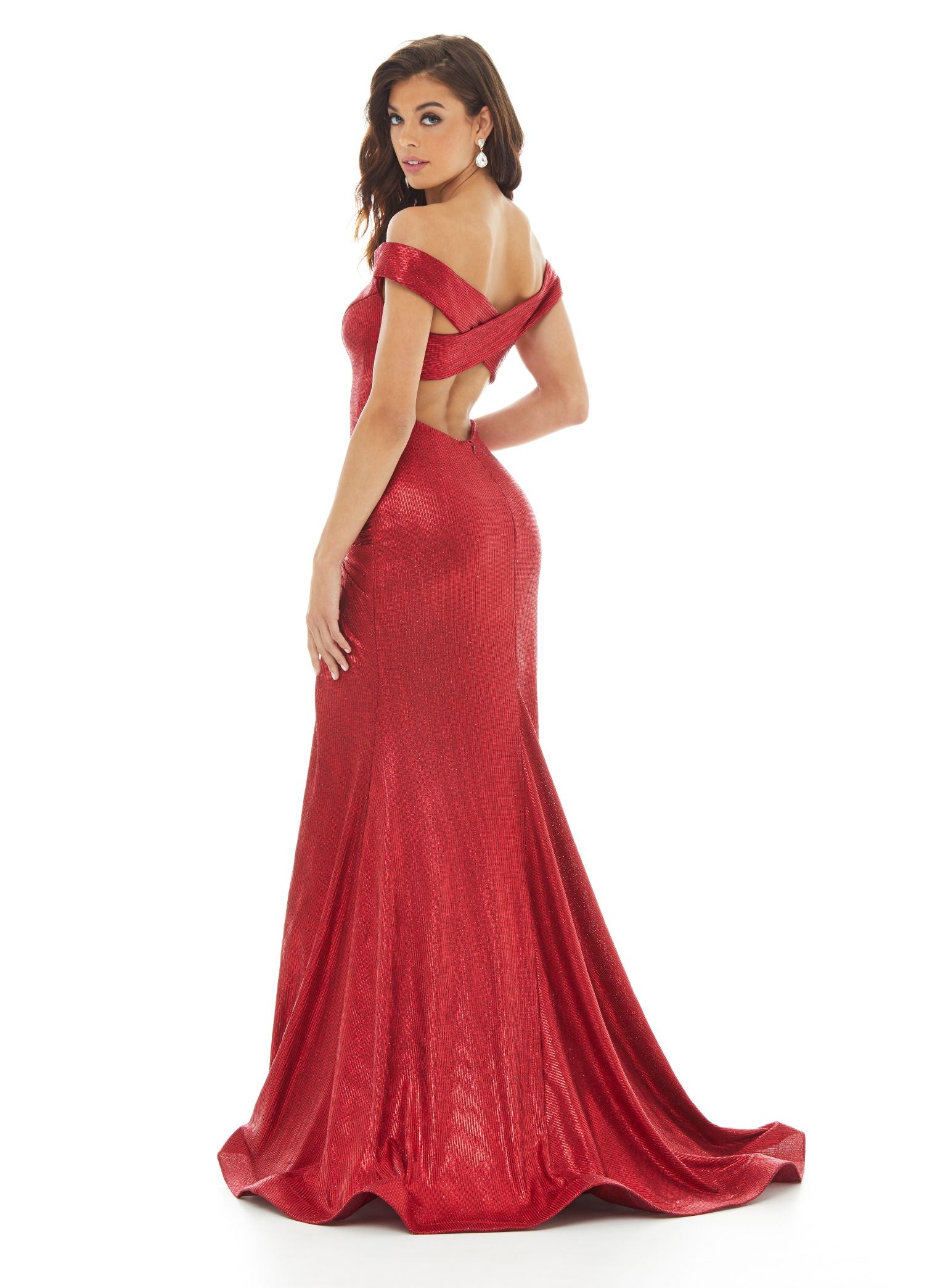 Ashley Lauren 11006 This metallic jersey off the shoulder evening gown is perfect for your next Prom or Pageant. The hip is accentuated with a twist knot detail that gives way to a high left leg slit. The skirt is finished with horsehair.   Colors Gunmetal, Red  Sizes 0, 2, 4, 6, 8, 10, 12, 14, 16    Off Shoulder Twist Knot Detail Criss Cross Back Fitted Skirt Metallic Jersey Prom Dress