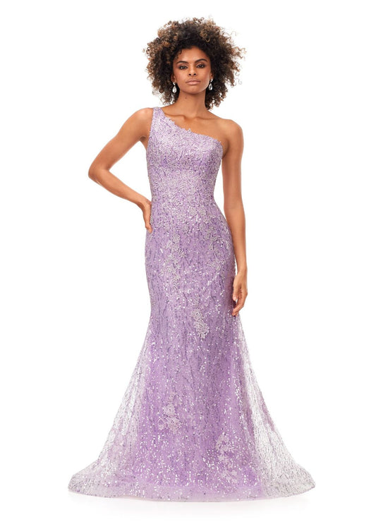 Ashley Lauren 11334 Feel ultra glamourous in this one shouldersequin gown. The bodice is embellished with lace appliques that cascade down onto the fitted skirt. The look is complete with a full zipper back. One Shoulder Fitted Skirt Sequin Applique Sweep Train COLORS: Sky, Lilac