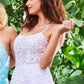 Jovani JVN06644 is a Long Lush Ballgown Prom Dress. This gown features a sheer fitted bodice with a scoop neckline and spaghetti straps. Floral lace appliques Embellish the top and cascade down into the full a line skirt. Open corset lace up tie back with a sweeping train.