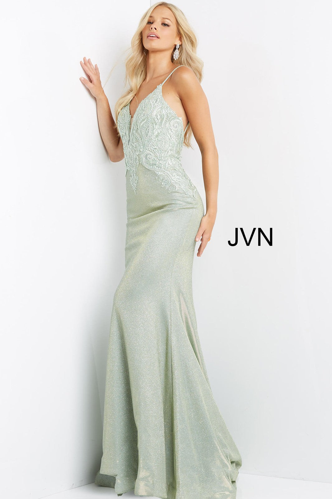 This JVN by Jovani JVN08492 light green prom gown has a fit and flare silhouette in stretch glitter, with a sheer inset plunging neckline and spaghetti straps. Tonal embroidery embellishes the bodice of this backless formal dress, finished with a horsehair hem and sweep train.  Available Sizes: 00-24  Available Colors: Light Green, Light Blue