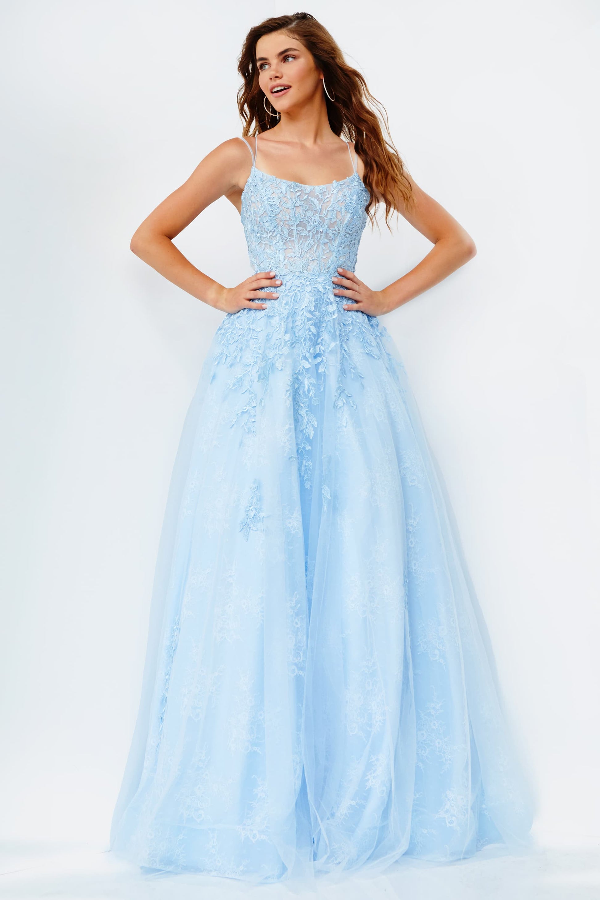 Jovani JVN06644 is a Long Lush Ballgown Prom Dress. This gown features a sheer fitted bodice with a scoop neckline and spaghetti straps. Floral lace appliques Embellish the top and cascade down into the full a line skirt. Open corset lace up tie back with a sweeping train light blue
