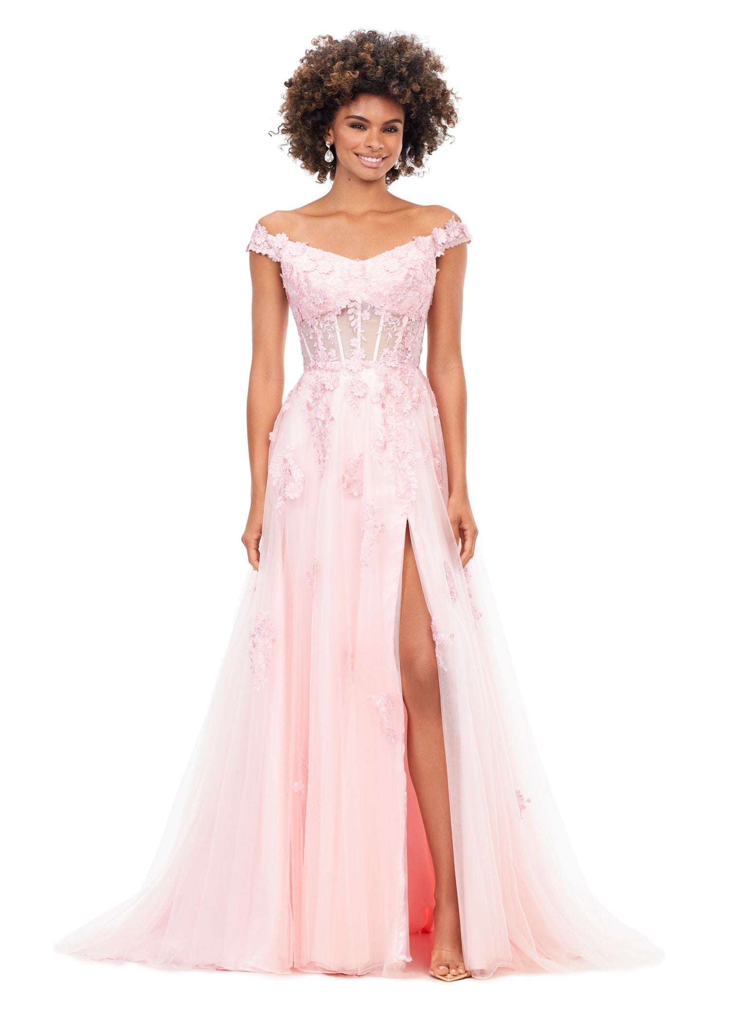Ashley Lauren 11376 This off the shoulder fairytail dream gown features an illusion corset and 3-dimensional lace flower appliques throughout layers of tulle. The look is complete with a left leg slit. Off Shoulder Neckline Illusion Bodice 3-Dimensional Lace Flower Appliques Tulle Black, Pink